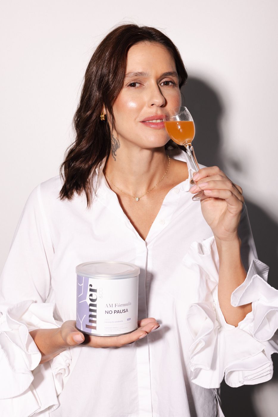 Mujer tomando el shot de la fórmula AM